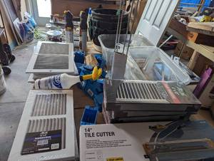 lot 74 image: Shelf filled with a new tile cutter...