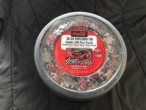 lot 144 image: Coca Cola Popcorn Tin Nascar Driving Your Thirst 4 Racing 500 Piece puzzle  Never been opened