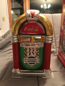 lot 173 image: Coca Cola Coke And A Song Chrome Metallic Look Jukebox Cookie Jar