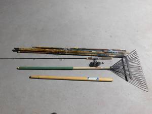 lot 274 image: Cane poles, fishing rod and reel, rake and wooden handle