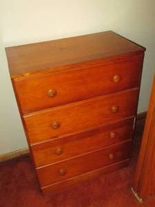 lot 108 image: Mid Height 4-drawer wood dresser....