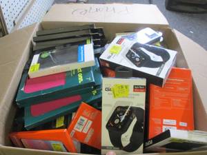 box of various phone covers and gla...