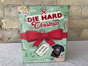 lot 23 image: FUNKO Pop Die Hard Holiday Pop Figure and Shirt Box Set. 