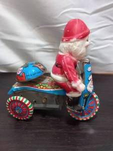lot 175 image: Vintage Wind Up Tin Litho Trike Tricycle With Plastic Santa