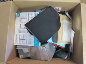 box of journals, name badges and mo...
