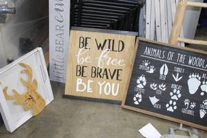lot 513 image: Lot of (4) Wall Decor - Moose Wall Clock, Little Bear Cave Wall Dcor, Be Wild Be Free Be Brave Be You Wall Dcor, Animals of the Woodlands Wall Dcor
