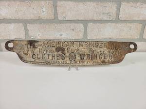 lot 88 image: Antique Cast Iron The American Wringer Co. New Horse Shoe Brand Wringer Washer Embossed Plate - Approx. 14 x 3