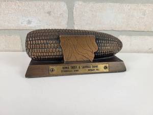 lot 154 image: IOWA Trust & Savings Bank Diecast Corn Cob Coin Bank - Estherville, IA - Approx. 6 x 2.5 x 2.5 - Includes Key