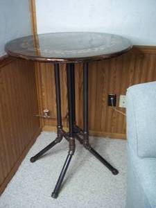 lot 3 image: Handmade by owners, unique table with metal pipe base.