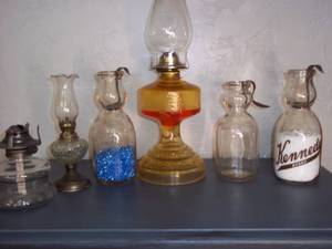 lot 25 image: Oil lamps and bottles with bent sil...