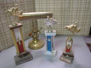 lot 242 image: Assorted Vintage Snowmobile Trophys with a brass tone desk lamp