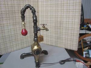 lot 278 image: Hand made using a faucet, a meter and some pipes we have a unique lamp to brighten the room and spark conversation