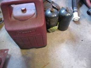 lot 314 image: Portable Coleman camping lantern with spare propane cylinders