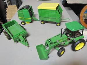 lot 415 image: Lot of die cast John Deere farm wagons and tractor.