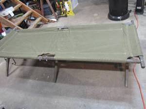 lot 424 image: Genuine US Army issued cot. They say these are more comfortable than a Sleep Number Nows your chance to find out.