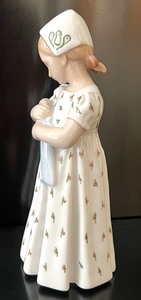 lot 114 image: Bing and Grndahl 1721 Figurine -  Bing and Grndahl Figurine Girl Holding Her Doll