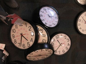 lot 161 image: PLASTIC WALL CLOCKS WITH STANDARD AND MILITARY TIME