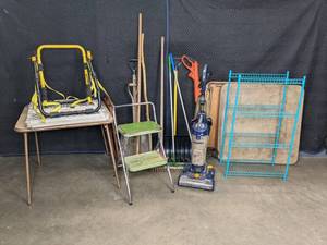lot 280 image: Mixed Lot Adjustable Baby Gate, Black & Decker Weedeater, Pair of Folding Card Tables, Eureka Vacuum, Yard Tools, Car Mounted Rack, Blue 4-Shelf Rack, and More  M