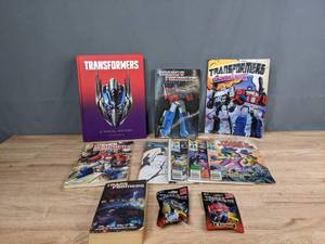 lot 65 image: A Collection of Transformers (11) Comic Books, Books, Mini Figurines, and More T