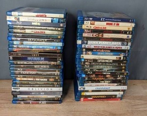 lot 56 image: Stack of (50) Blu-Ray DVDs Jaws, Lights Out, Skyscraper, Lucy, Independence Day, Inception, Oblivion, Gremlins, Cast Away, Oceans Thirteen, Taken, Cold Pursuit, Wanted and More T