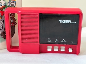 lot 129 image: Vintage Tiger Story Reader Cassette Player and Set of Disney Sing Along Cassette Tapes and Books