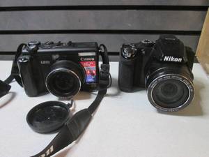 2 Digital Cameras Nikon CoolPix P50...