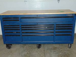 lot 1 image: Husky 72 in. W x 24 in. D Heavy Duty 18-Drawer Mobile Workbench Cabinet with Adjustable-Height Solid Wood Top in Matte Blue Has Some Damage See Photos