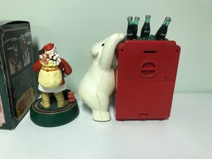 lot 24 image: Coca Cola mechanical Santa Claus bank & polar bear alarm clock  coin bank