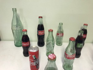 lot 69 image: Lot of Coca Cola bottles and 2 cans