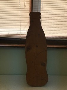 lot 96 image: Puzzle glued to a piece of wood cut out like a coke bottle