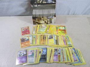 lot 313 image: (EC1) Assorted Pokemon Cards in Tin...