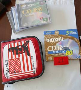 lot 21 image: New Motley Crue CD case and New CDs