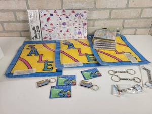 lot 865 image: Keychains, Garden Flags, New CDs and Red Hat ladies Magnets