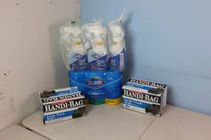 2 Trash bags, 3 pack of Clorox wipes, and 3 Clorox spray cleaner bottles