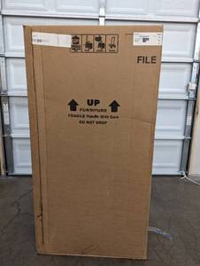 Staples brand four drawer vertical black filing cabinet