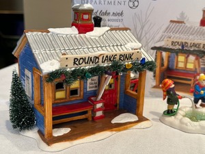 lot 52 image: Department 56 Snow Village Round Lake Rink, Future Hockey Stars Figurine and More