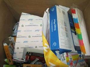 box of paper, pens, bandages and mo...