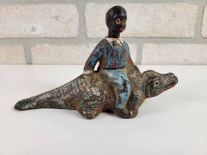 lot 323 image: Antique Cast Iron Boy Riding Alligator - Head Turns