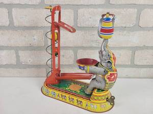 lot 390 image: JW Tin Wind Up Toy Circus Elephant with Lifted Balls - WORKS - Made in Germany (US Zone)