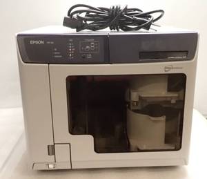 lot 32 image: Epson PP-50 Discproducer Standard 50 Disc Publisher  15 CDs or 8 DVDs per hour  Six high capacity ink cartridges (ink levels unknown) and Power Cable Included  Power Tested On