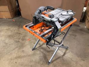 lot 18 image: RIDGID 9 Amp Corded 7 in. Wet Tile Saw with Stand, Customer return, Review all pictures