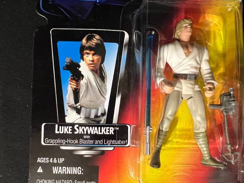 Luke Skywalker with grappling-hook blaster and lightsaber