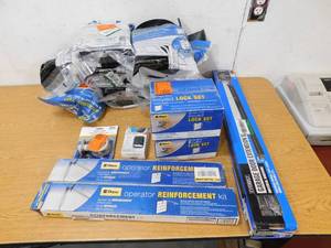 lot 10 image: Assorted garage door lot of items, Weatherstip for 18 door , locks, brackets