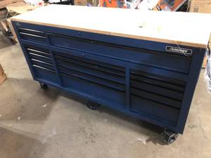 lot 19 image: Husky  72 in. W x 24 in. D Heavy Duty 18-Drawer Mobile Workbench Cabinet with Adjustable-Height Solid Wood Top in Matte Blue