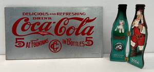 lot 30 image: Vintage Coca Cola Sign And Limited Edition 75th Anniversary 2006 Coca Cola Santa Bottle Olny 750 Bottles Made