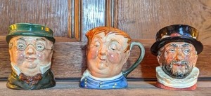 lot 33 image: Three Vintage Miniature Toby Mugs