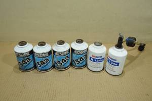 lot 26 image: 6 134a Refrigerant AC Charges with Gauge