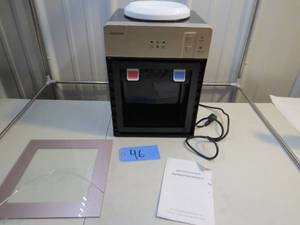 lot 46 image: Top Loading Small Countertop Water Cooler Dispenser 5 Gallon Cold and Hot Water Dispenser Glass Door is cracked