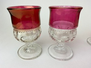 lot 34 image: 8 Tiffin Kings Crown Thumbprint Pattern Ruby Flashed Iridescent Gold Rimmed Sherry Glasses