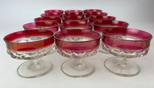 lot 58 image: Tiffin Kings Crown Thumbprint Pattern Ruby Flashed Iridescent Gold Rimmed Sherbert  Coupe Glasses